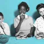 Edwin Gonzalez, Iris Alomar, and Ray Gerdes, the three winners in the inaugural hamburger eating contest at the Police Athletic League youth center on West 79th Street in NYC, c. 1955 Getty