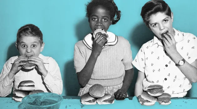 Edwin Gonzalez, Iris Alomar, and Ray Gerdes, the three winners in the inaugural hamburger eating contest at the Police Athletic League youth center on West 79th Street in NYC, c. 1955 Getty